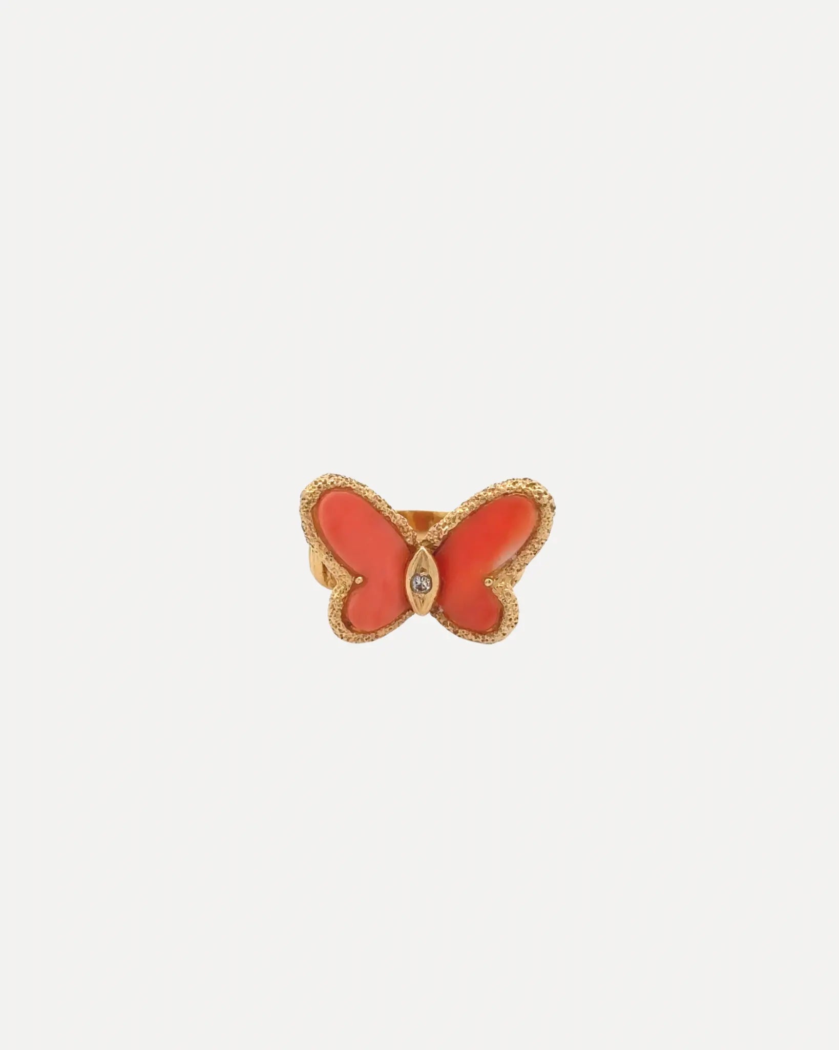 A gold & coral ladies butterfly ring by Van Cleef and Arpels.