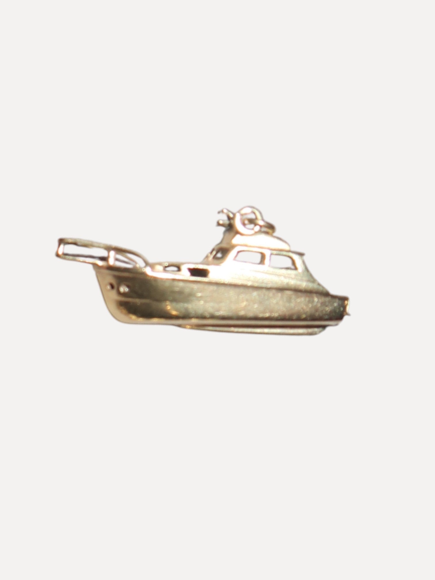 Gold boat-shaped pendant on a white background