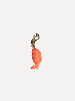 Coral fish charm with gold clasp on a white background