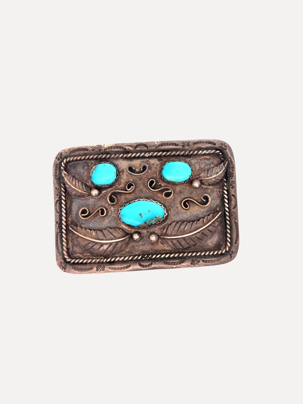 A rectangular silver-toned belt buckle featuring three turquoise stones in a Southwestern-style design, set against a plain light gray background.