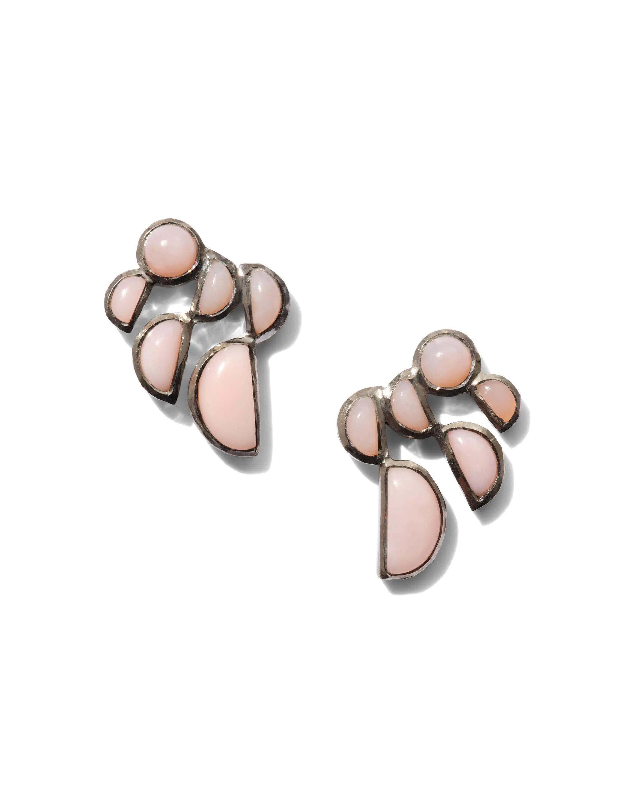 Designed by Nak Armstrong these earrings are so much fun. They are set in sterling silver with a black rhodium finish and pink opal. They measure 3/4" in diameter and are post and nut closure.