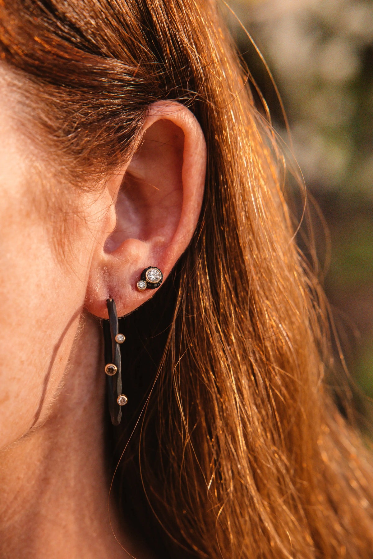 Rouge hoop earrings paired with white diamond stud earrings designed Sarah Graham