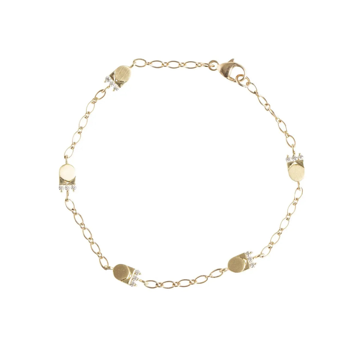 The Crown bracelet will make you feel like pure royalty. Wrap your wrist up in this perfectly dainty bracelet and add just the right amount of sparkle to your stack.    15 round ethically sourced diamonds  Total carat weight: .15 18K recycled yellow gold Measurements: 6.8mm/.27in tall, 4.3mm/.17in wide, 2.1mm/.08in deep (each station on the bracelet) 18K lobster clasp and oval cable chain bracelet is adjustable up to 7.25 inches Designed by Alex Fitz