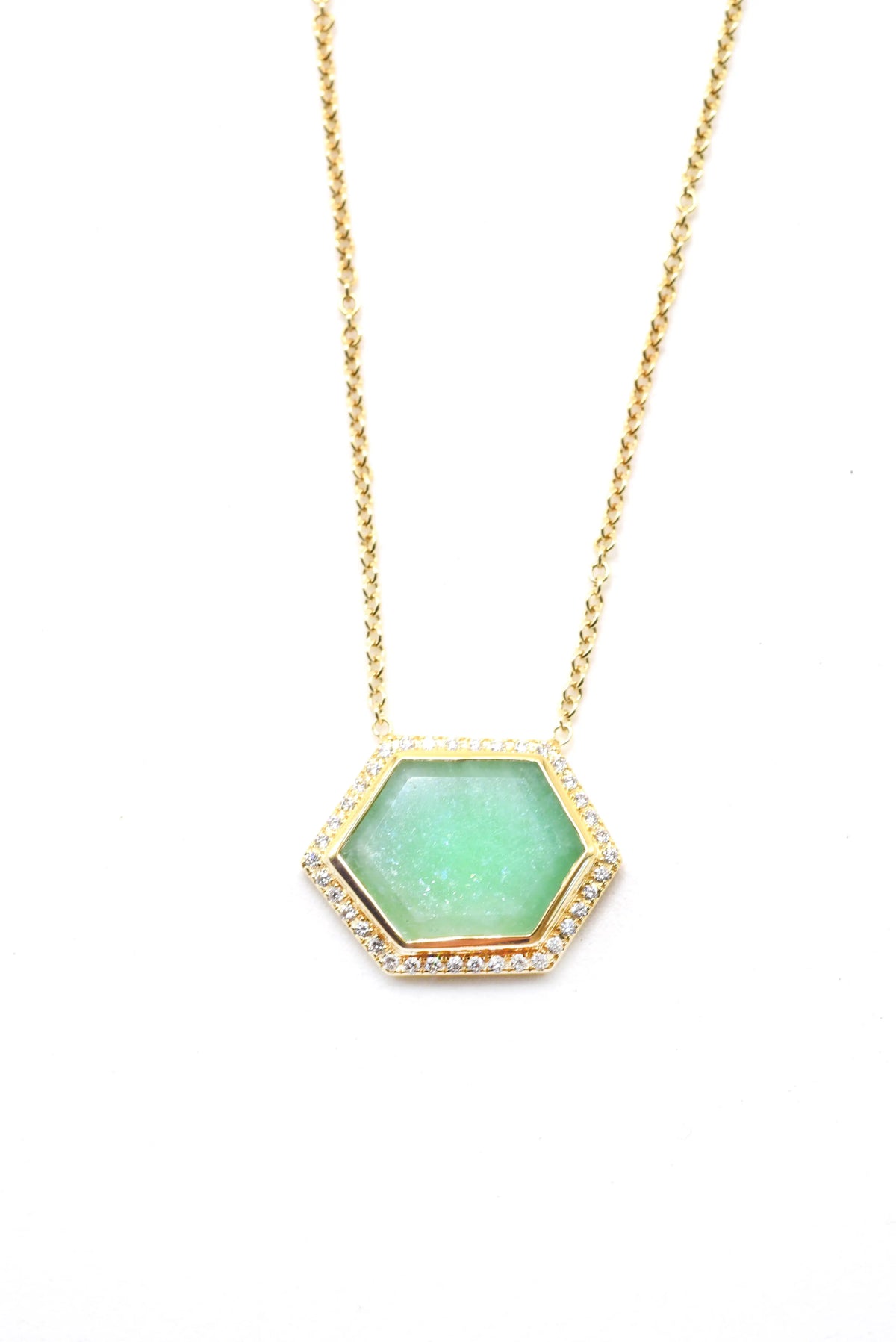 Emerald Slab Necklace with a diamond hexagon halo. The emerald slab is 6.72 cttw and the diamonds are .22 cttw. It is set in 18k yellow and is on a 18 in chain.