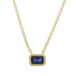 14k yellow gold with a classic east west set emerald cut blue sapphire for the perfect pop of color. This is great on its own or stacked. The bezel measures 6x4mm. The chain is 16 inches.