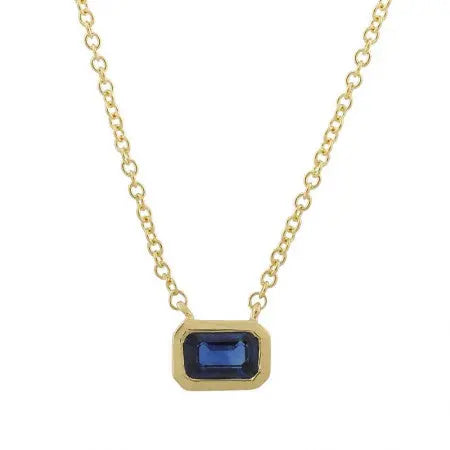 14k yellow gold with a classic east west set emerald cut blue sapphire for the perfect pop of color. This is great on its own or stacked. The bezel measures 6x4mm. The chain is 16 inches.