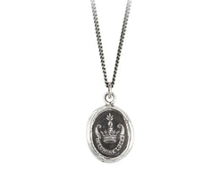 This talisman reads 'In Lumine Luce' in Latin, which means 'Shine in the Light'. The arm coming out of a crown is symbolic of leadership and achievement. It is holding a sheaf of wheat which represents the fruition of one's hopes and dreams.   Handcrafted in Vancouver, Canada Cast in 100% recycled sterling silver or bronze Sterling silver chain 18 inches and lobster clasp with Pyrrha branded quality tag Meaning card (handmade from recycled materials)