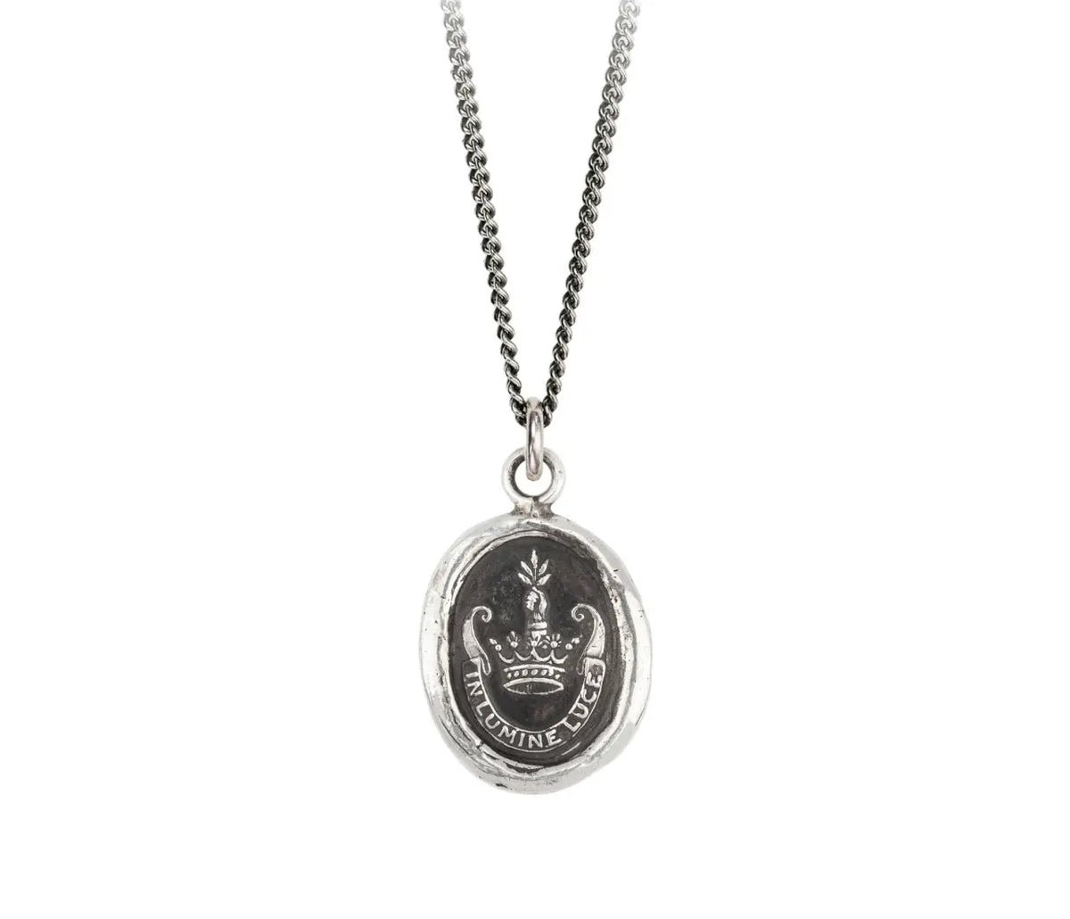 This talisman reads &#39;In Lumine Luce&#39; in Latin, which means &#39;Shine in the Light&#39;. The arm coming out of a crown is symbolic of leadership and achievement. It is holding a sheaf of wheat which represents the fruition of one&#39;s hopes and dreams.   Handcrafted in Vancouver, Canada Cast in 100% recycled sterling silver or bronze Sterling silver chain 18 inches and lobster clasp with Pyrrha branded quality tag Meaning card (handmade from recycled materials)