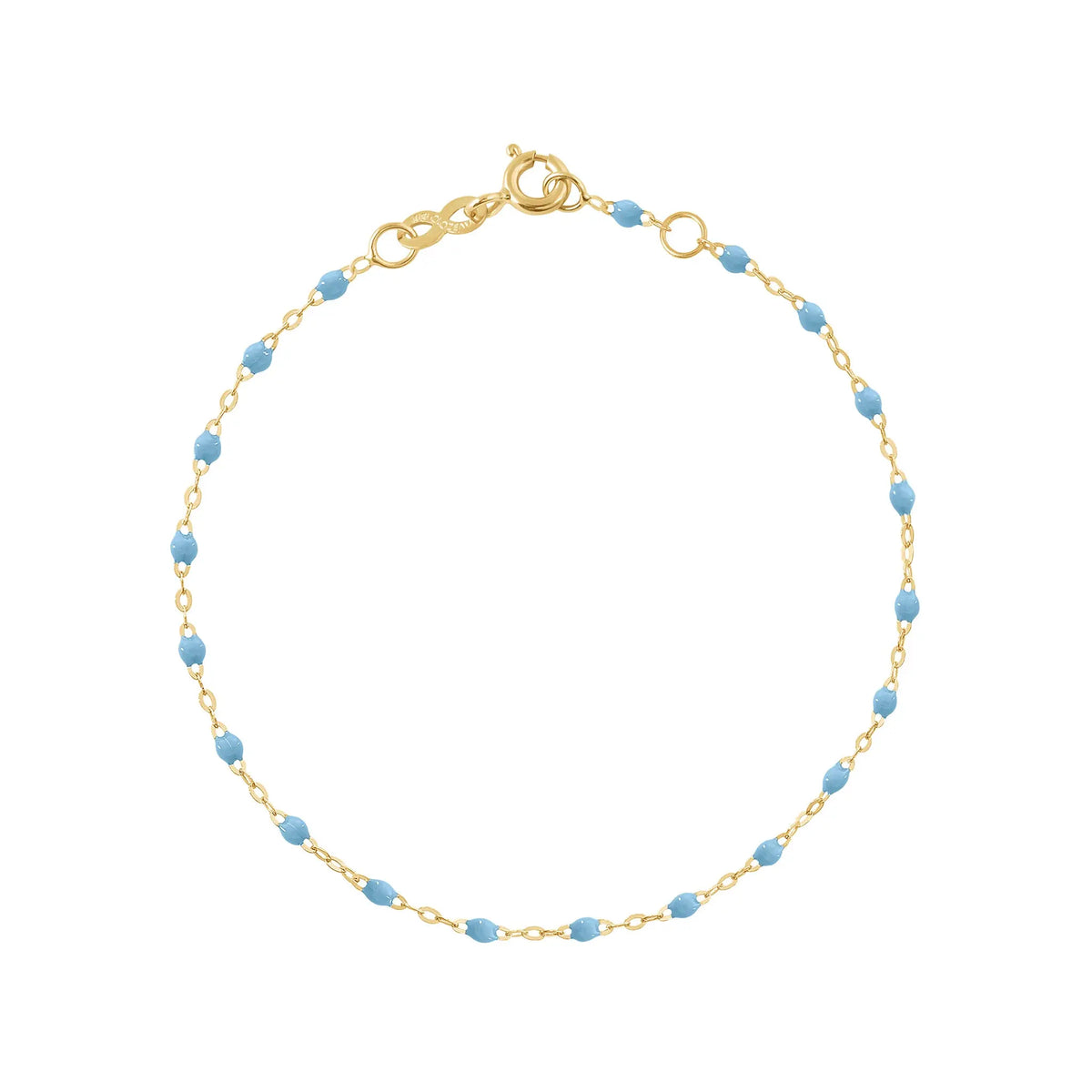 The Classic Gigi bracelet by gigi CLOZEAU features 18K Yellow Gold, and unique Turquoise jewels for a simple, everyday look.   Each jewel is unique, artisanally made in their family-owned workshop. 18K yellow gold and resin. The bracelet measures 6.7 inches with adjustable clasp at 6.3 inches.