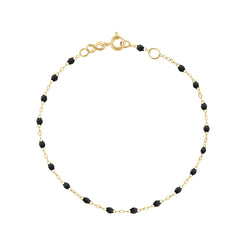 The Classic Gigi bracelet by gigi CLOZEAU features 18K Yellow Gold, and unique Black jewels for a simple, everyday look.   Each jewel is unique, artisanally made in their family-owned workshop. 18K yellow gold and resin. The bracelet measures 6.7 inches with adjustable clasp at 6.3 inches.