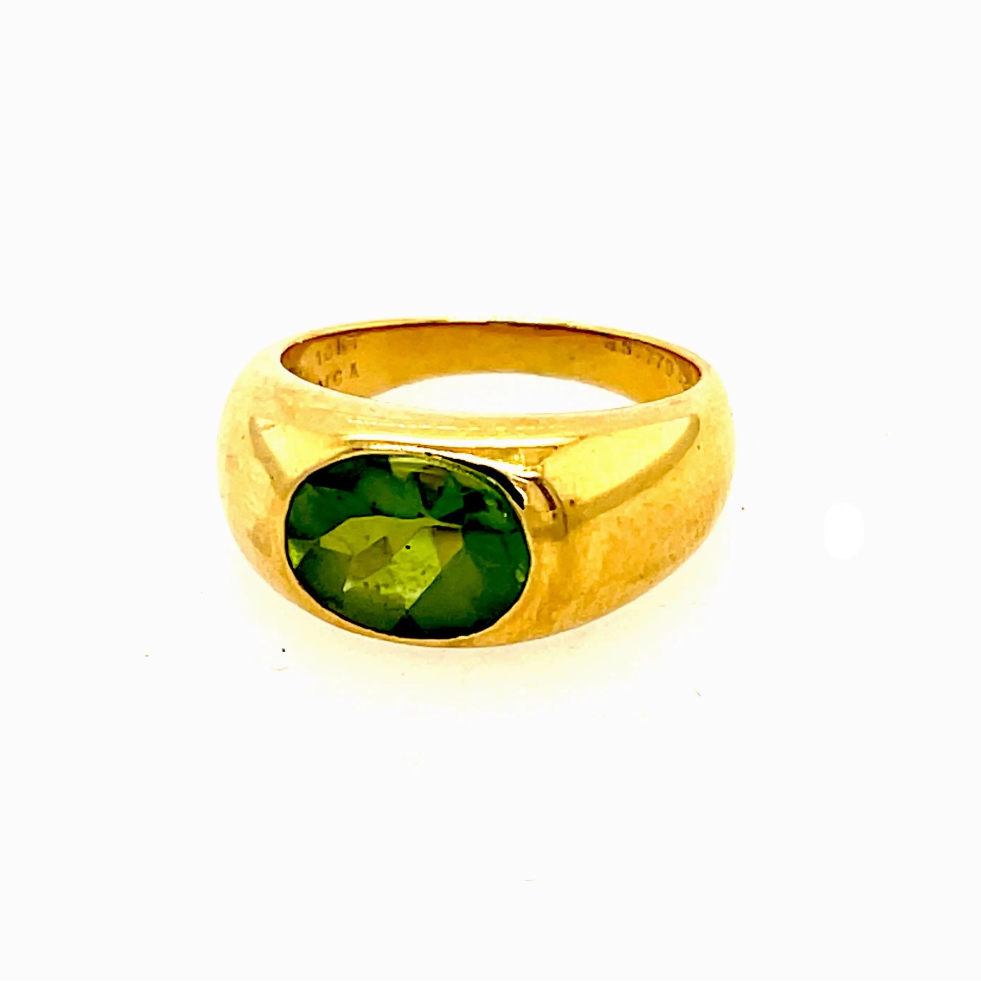 One Vintage Van Cleef & Arpels Peridot 18 Karat Gold Bezel Set Ring. Featuring one oval shaped peridot of approximately 2.70 carats. Crafted in 18 karat yellow gold, signed VCA, serial #B5777D32, with French hallmarks. Circa 1990s.