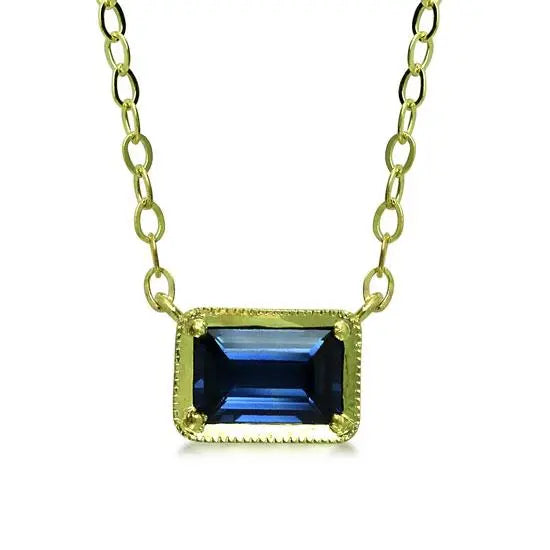 Leone Sapphire NecklaceOur classic east-west set emerald cut blue sapphire radiates a soothing blue shade for that perfect pop of color on your neckline.  14K sustainable gold 0.65ct emerald cut blue sapphire 16&quot; chain with 15&quot; option, lobster clasp closure  Dimensions:  1/3&quot; x 1/4&quot;  Designed by ILA