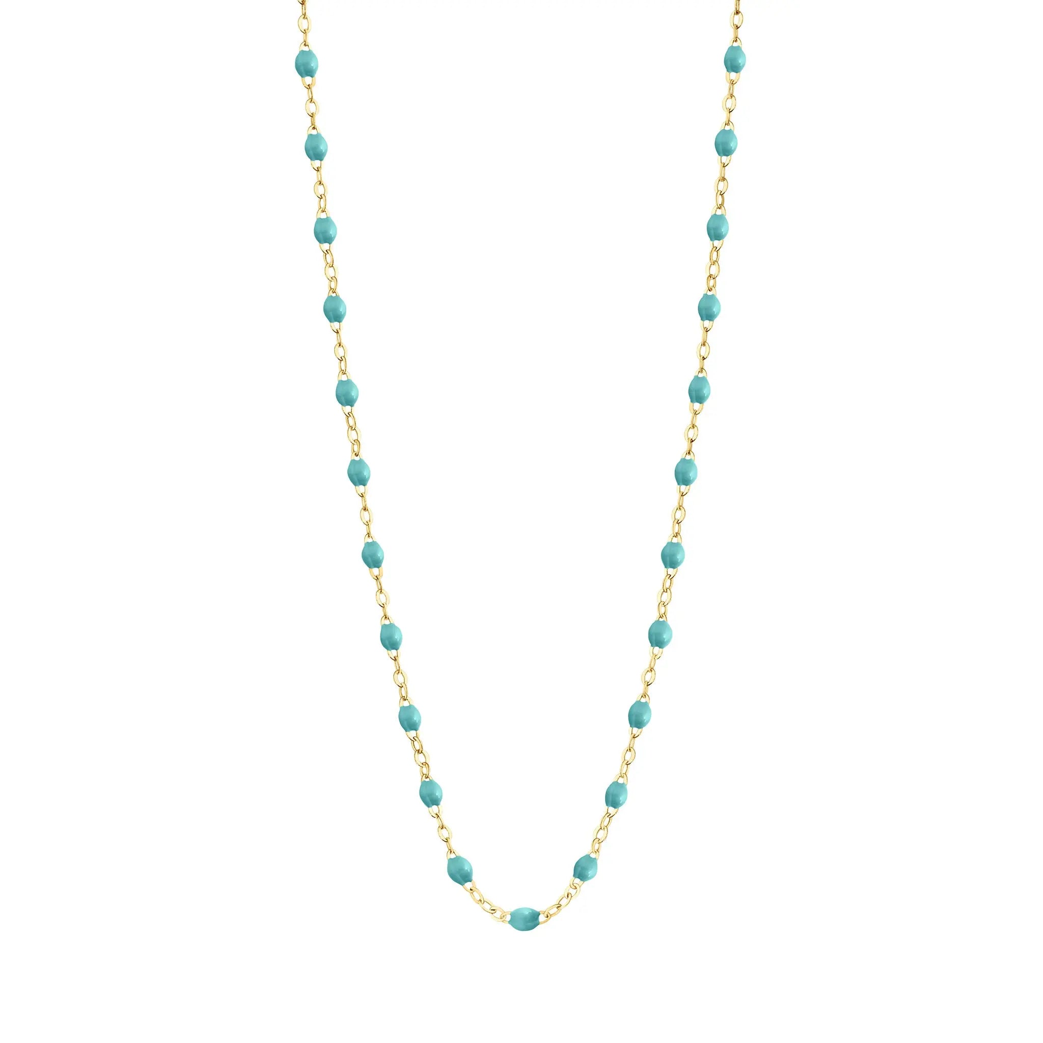 Stack you necklace layers with this versatile beaded chain! The Classic Gigi Necklace by gigi CLOZEAU features 18 carat yellow gold, and striking Turquoise Green resin jewels for an everyday effortless appearance. Handcrafted in 18k yellow gold. The beads measure 1.50mm in diameter and is finished with a spring ring clasp. The length is 19.7 inches.