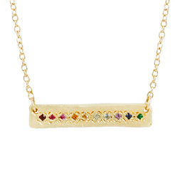La Fortuna Necklace-Rainbow  A soft bar crafted from 18k gold is set with a glittering rainbow of precious stones, including (but not limited to) ruby, sapphire, emerald, and amethyst.  Length: 16" chain  Aili Jewelry is made in New York City from recycled metals provided by sustainable certified companies and conflict free diamonds.