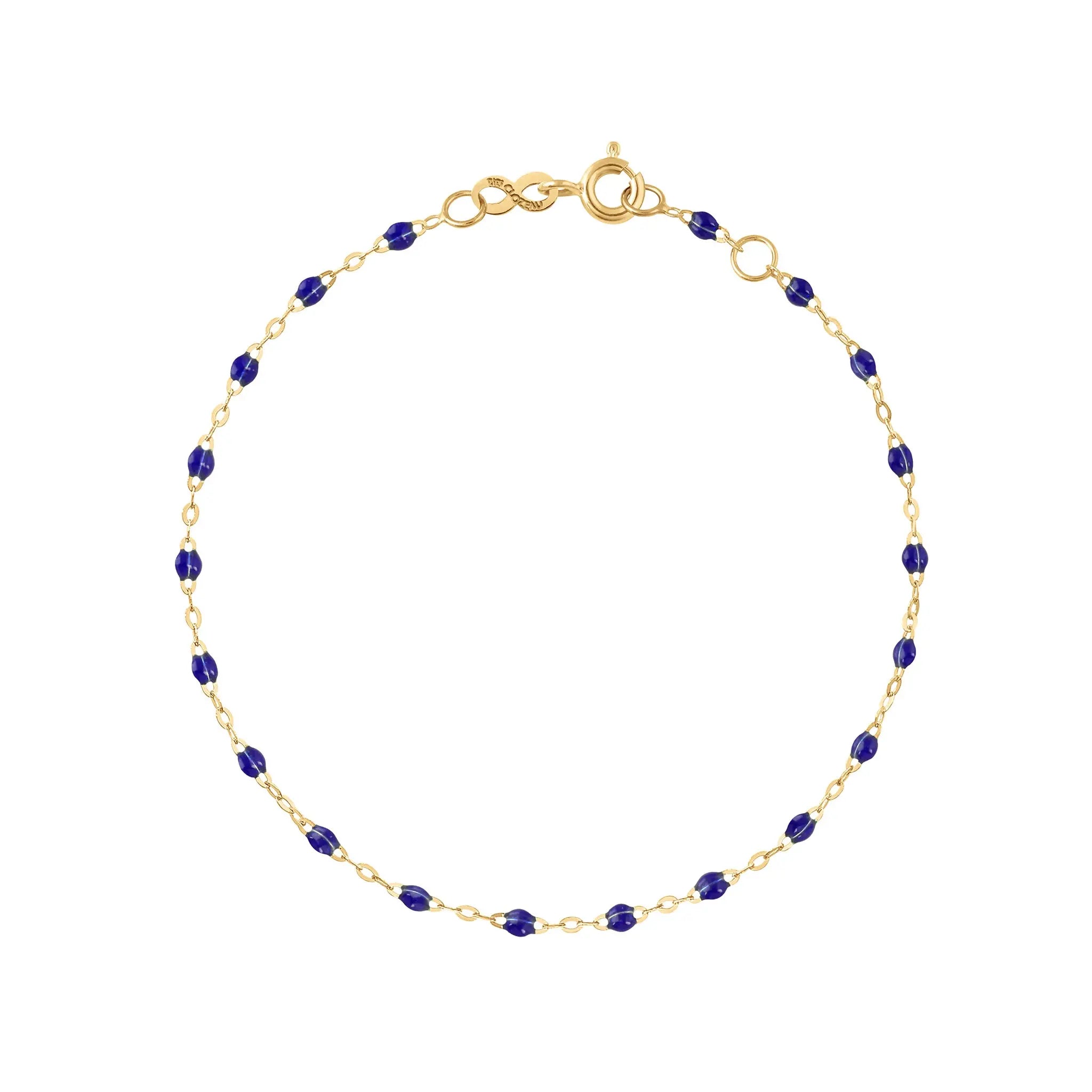 The Classic Gigi bracelet by gigi CLOZEAU features 18K Yellow Gold, and unique Lapis jewels for a simple, everyday look.   Each jewel is unique, artisanally made in their family-owned workshop. 18K yellow gold and resin. The bracelet measures 6.7 inches with adjustable clasp at 6.3 inches.