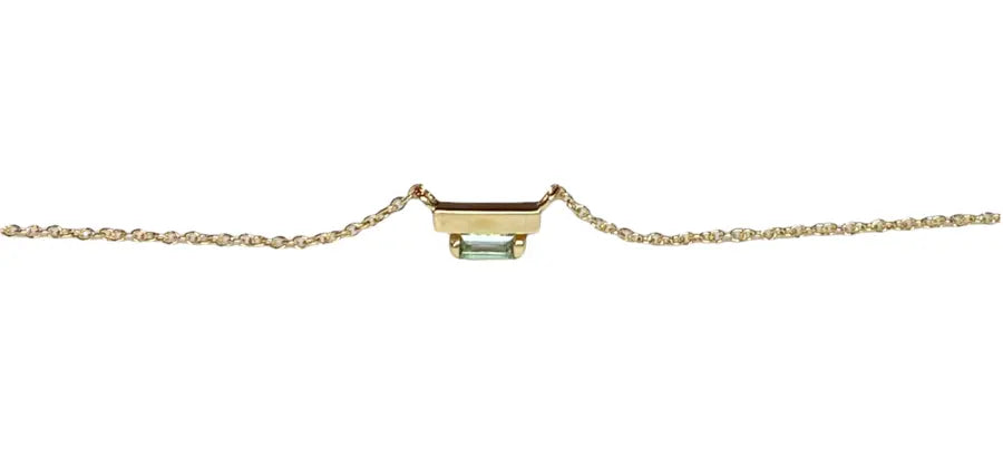 The Ladder Climber Necklace perfectly compliments our Ladder Climber earrings.  4x2mm sea foam tourmaline baguette suspended under a solid 18k recycled gold bar.  4x2mm tourmaline baguette Total carat weight: 0.13 18K recycled yellow gold Designed by Alex Fitz