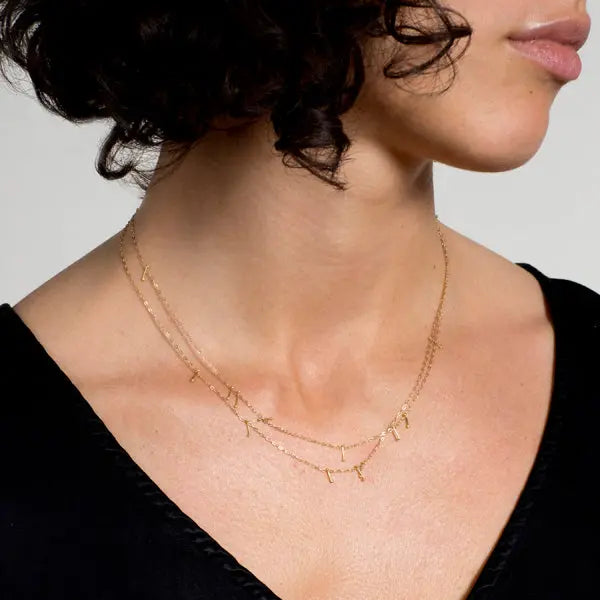 Long 14k gold chain pinned with 18k gold. Necklace can be worn long or doubled.