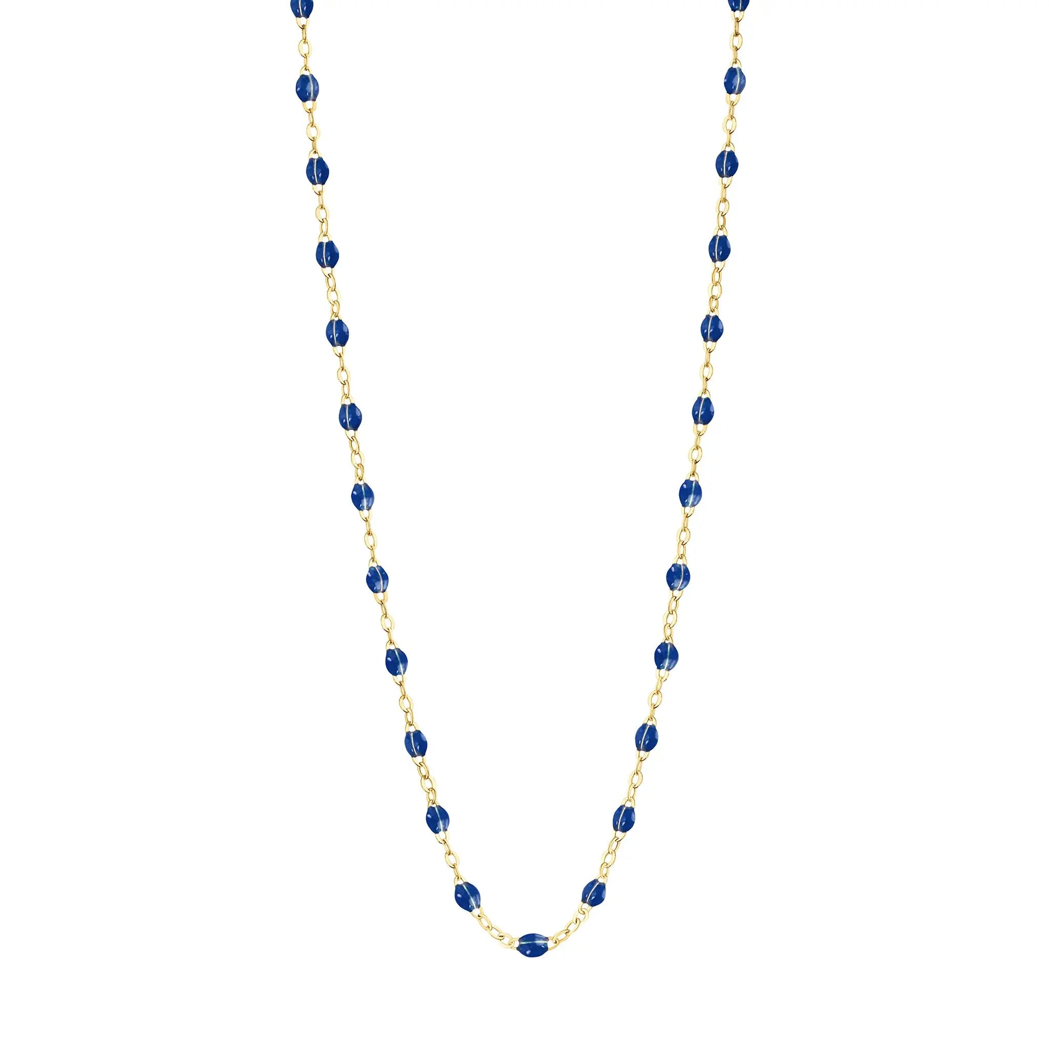 Stack you necklace layers with this versatile beaded chain! The Classic Gigi Necklace by gigi CLOZEAU features 18 carat yellow gold, and striking Lapis resin jewels for an everyday effortless appearance. Handcrafted in 18k yellow gold. The beads measure 1.50mm in diameter and is finished with a spring ring clasp. The length is 16.5 inches.