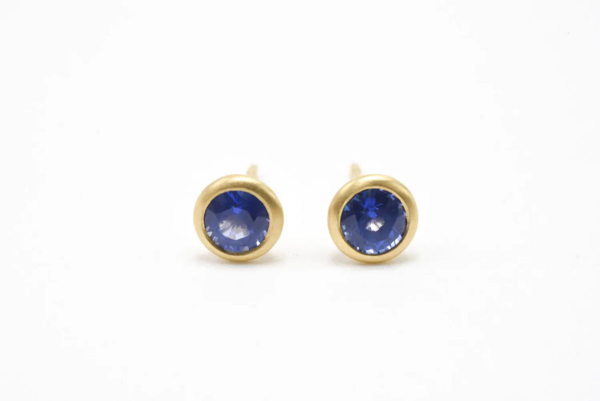 These make a great stack. 18k yellow gold blue sapphire studs with 1.30 cttw set in 18k yellow gold. Sold as a pair.