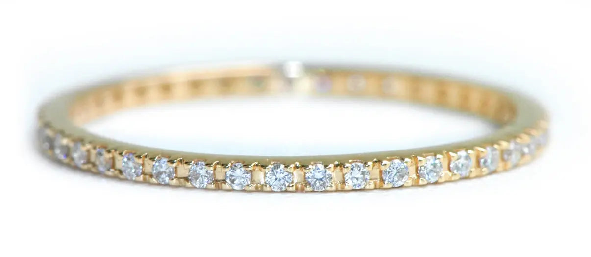 18k yellow gold Eternity Band with White Diamonds ~.30 cttw. This is great on its own are stacked with 2 more bands. The ring size 6.