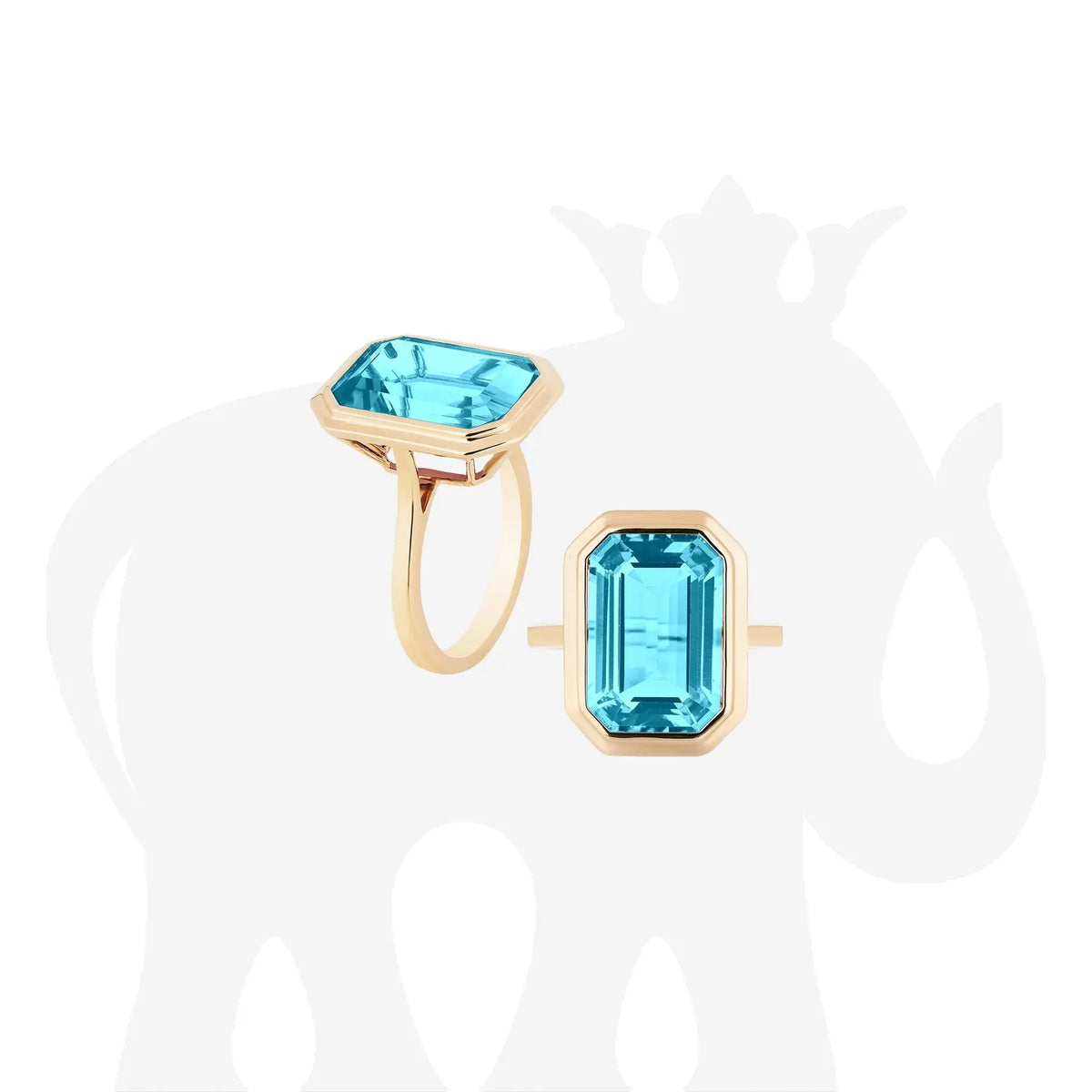 Manhattan&#39; Blue Topaz Emerald Cut Bezel Set Plain Gold Ring in 18k yellow gold. The stone size is 10x15mm. The blue topaz is 9.38 cttw.