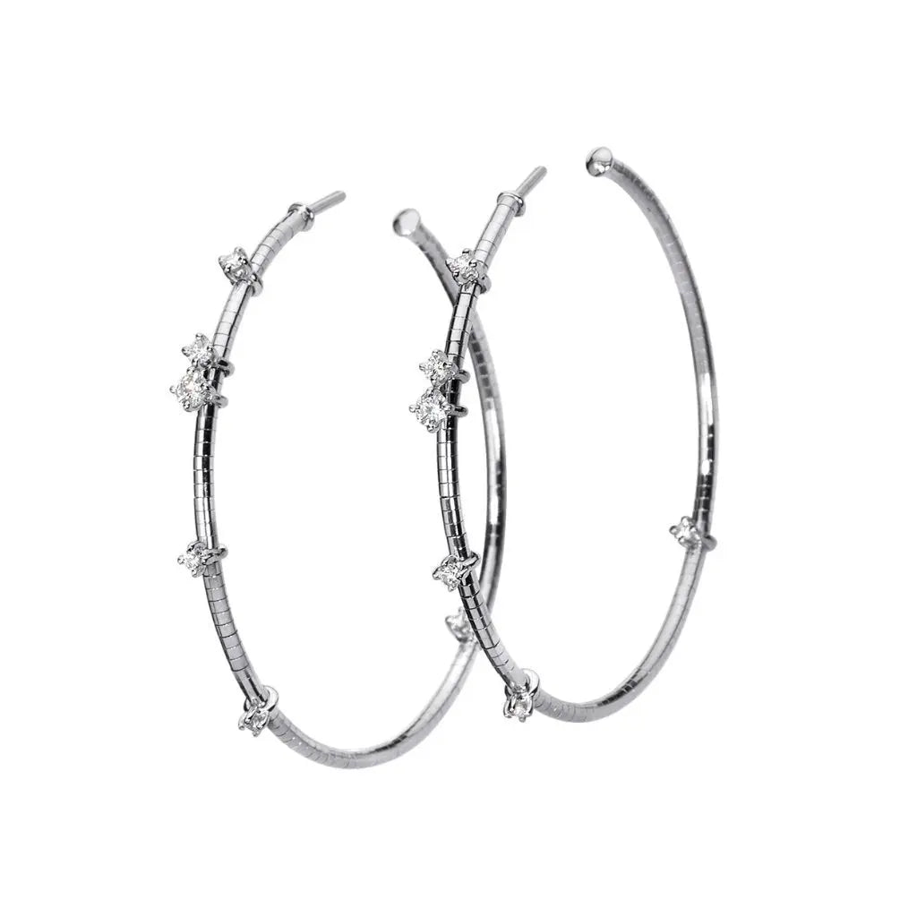 18k white gold diamond hoops with lightweight titanium core for durability and flexibility .29 cttw of full cut, round brilliant diamonds.  Hoop size 1.5 inches   If an item is out of stock, please allow 8-12 weeks for delivery.   Designed by Mattia Cielo and made in Italy