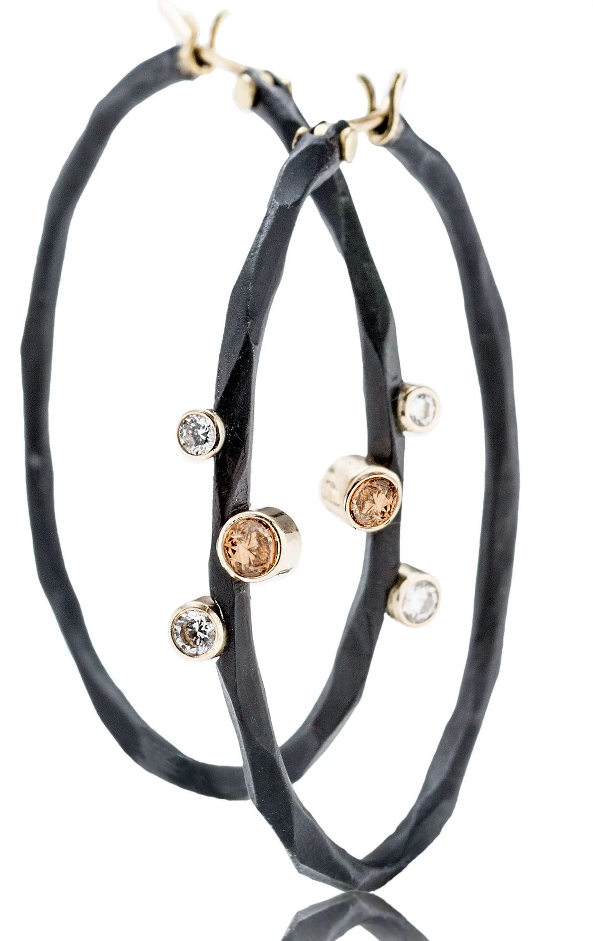 Blackened cobalt chrome and 18kt gold hoop earrings with .06ctw of white brilliants and .14ctw of cognac diamonds. Great hoops!