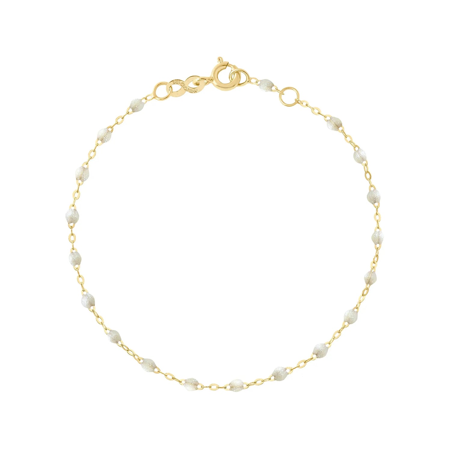 The Classic Gigi bracelet by gigi CLOZEAU features 18K Yellow Gold, and unique Opal jewels for a simple, everyday look.   Each jewel is unique, artisanally made in their family-owned workshop. 18K yellow gold and resin. The bracelet measures 6.7 inches with adjustable clasp at 6.3 inches.