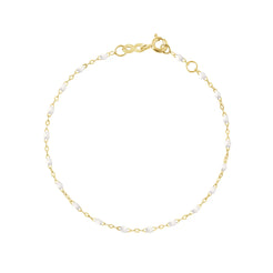 The Classic Gigi bracelet by gigi CLOZEAU features 18K Yellow Gold, and unique White jewels for a simple, everyday look.   Each jewel is unique, artisanally made in their family-owned workshop. 18K yellow gold and resin. The bracelet measures 6.7 inches with adjustable clasp at 6.3 inches.