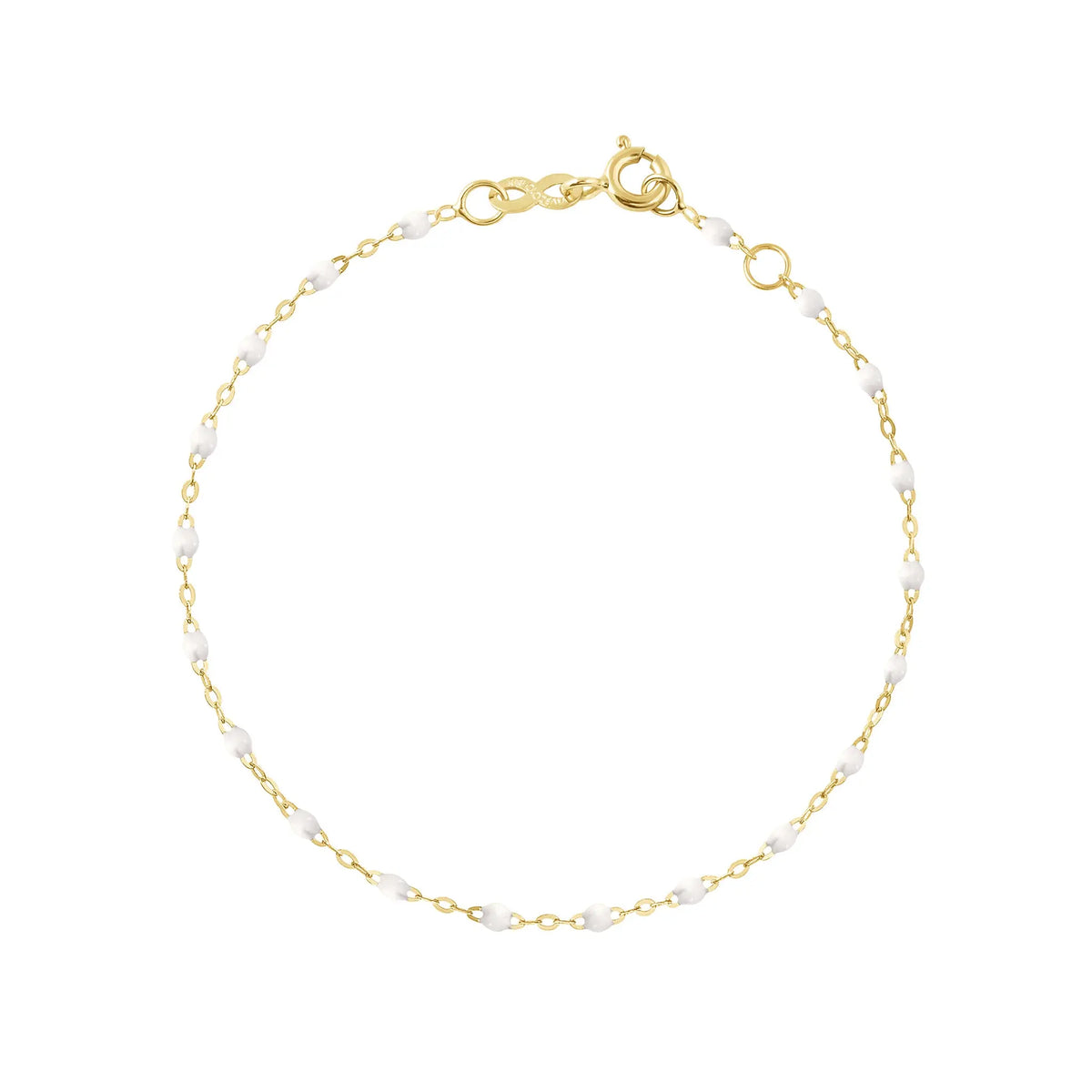 The Classic Gigi bracelet by gigi CLOZEAU features 18K Yellow Gold, and unique White jewels for a simple, everyday look.   Each jewel is unique, artisanally made in their family-owned workshop. 18K yellow gold and resin. The bracelet measures 6.7 inches with adjustable clasp at 6.3 inches.