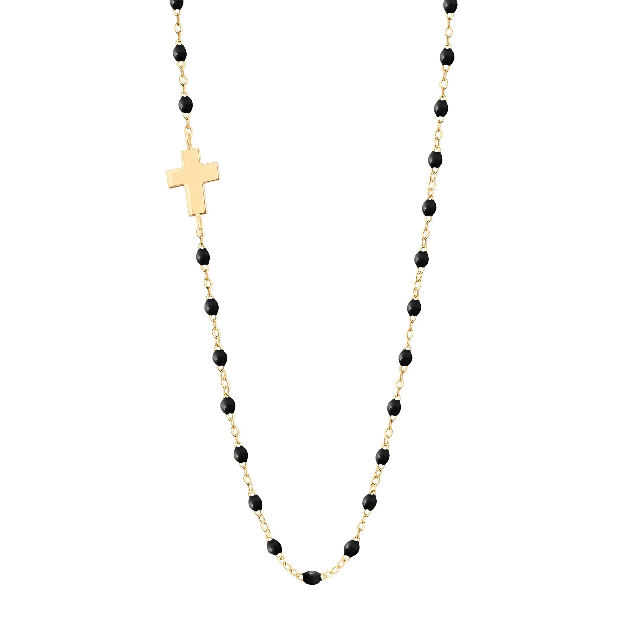 The Classic Gigi Cross Charm necklace with Black resin pearls by gigi CLOZEAU features signature 18 carat Yellow Gold and a timelessly elegant design. Each jewel is unique, artisanally made its our family-owned workshop. The length is 16.5 inches with adjustabe clasp at 16.1 inches.