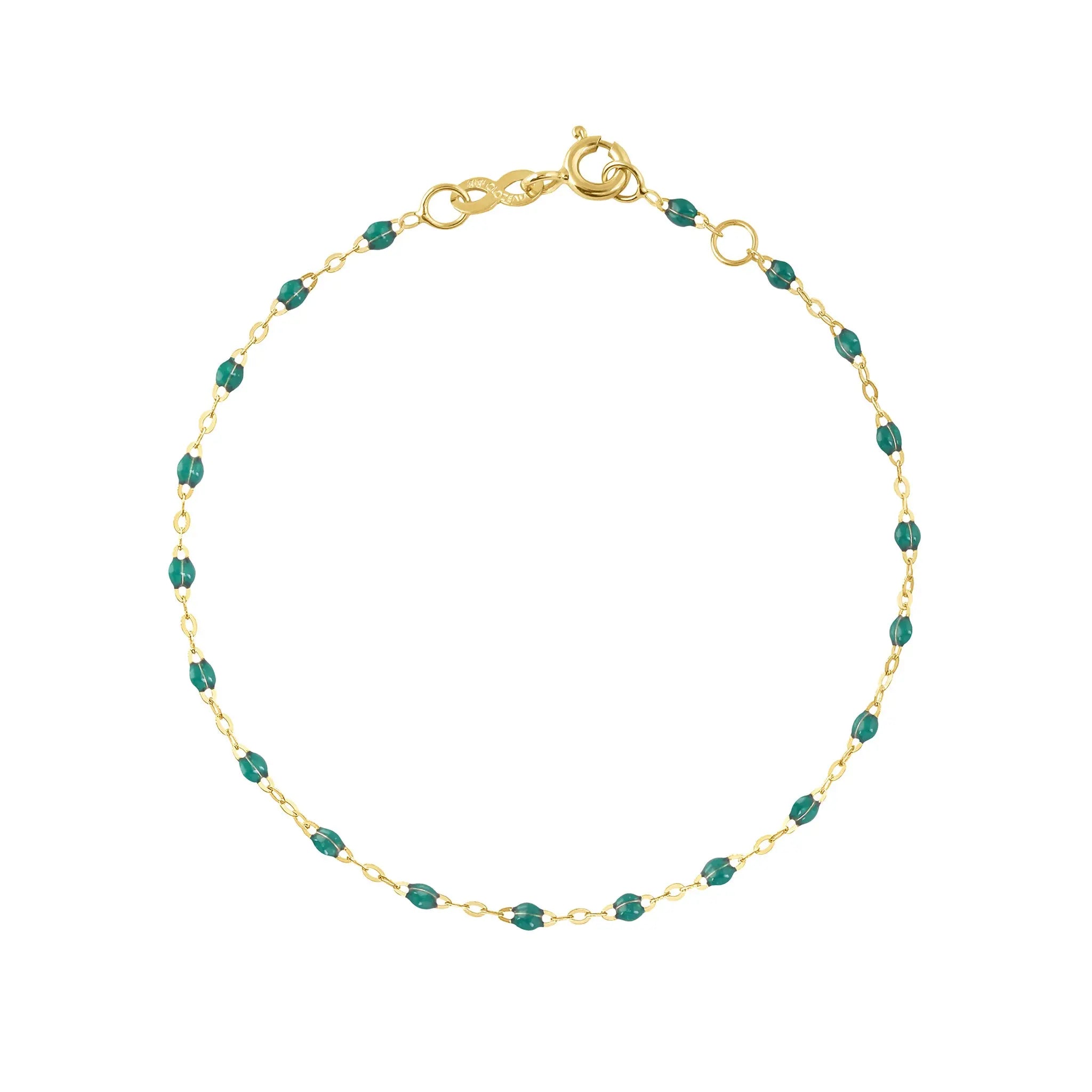 The Classic Gigi bracelet by gigi CLOZEAU features 18K Yellow Gold, and unique Emerald jewels for a simple, everyday look.   Each jewel is unique, artisanally made in their family-owned workshop. 18K yellow gold and resin. The bracelet measures 6.7 inches with adjustable clasp at 6.3 inches.