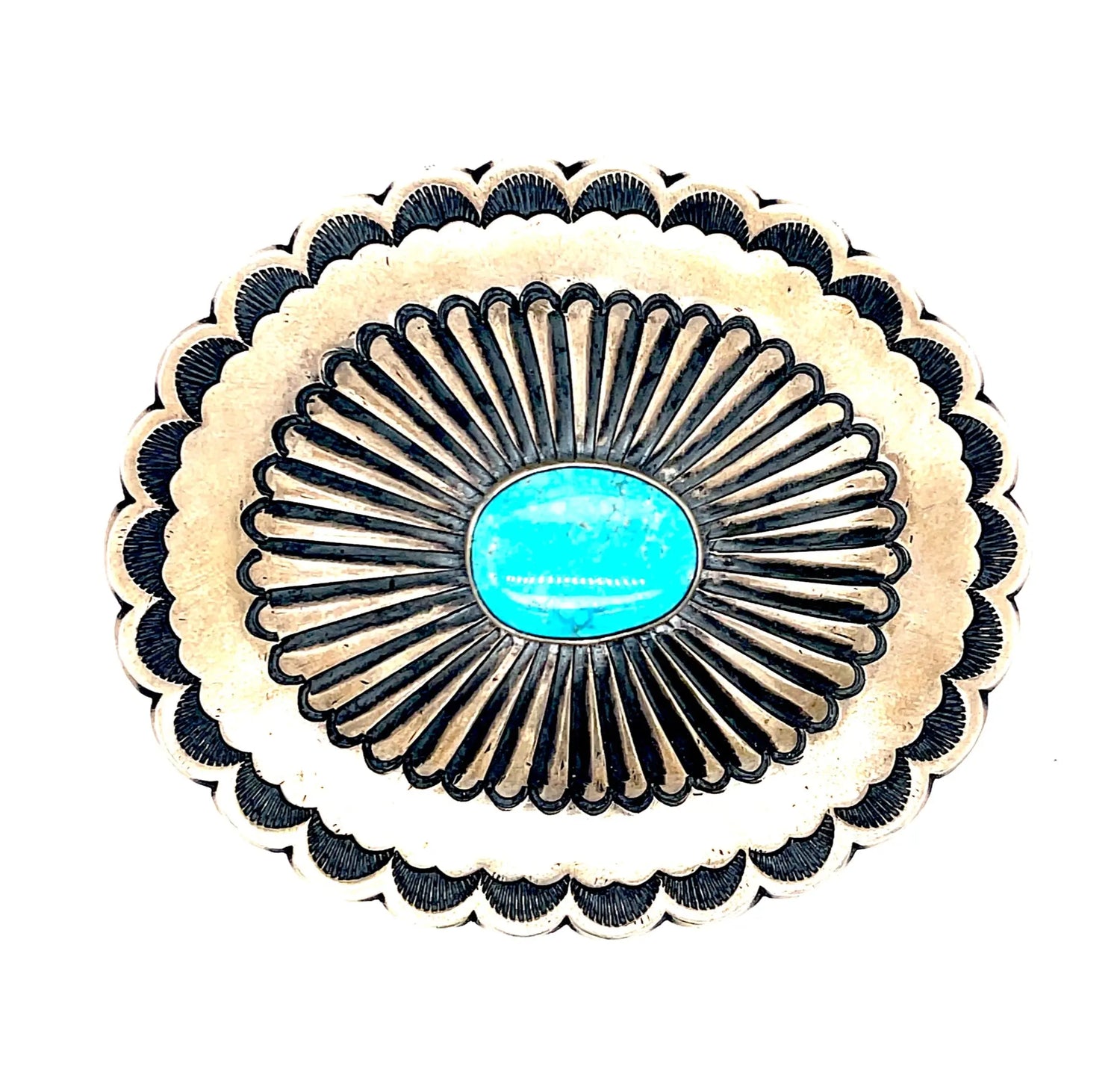 Sterling Turquoise Repousse Stamped Buckle with a round piece of turquiose. The length of the buckle is ~2.5 inches x 2 inches. The shape is oval.