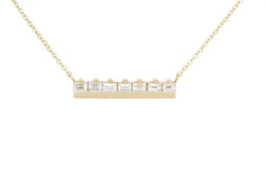 The At the Bar 7 baguette necklace is a classic piece, for a classic lady.  7 gorgeous baguettes sitting up at a solid 18k recycled gold bar.  7 ethically sourced baguette diamonds  Total carat weight: 0.7 18K recycled yellow gold Measurements: 4.4mm/.17 inches high, 22.3mm/.88 inches wide Designed by Alex Fitz