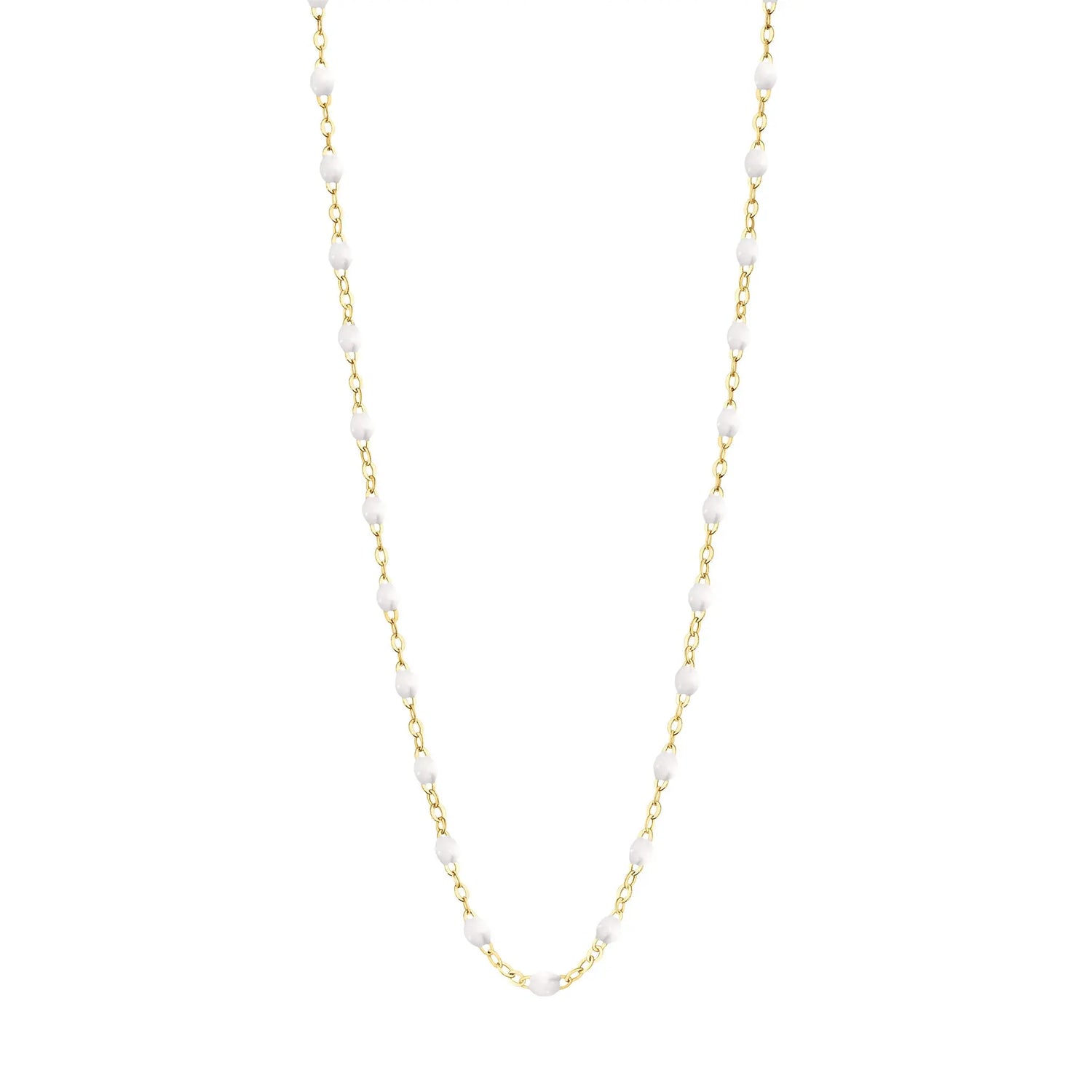 Stack you necklace layers with this versatile beaded chain! The Classic Gigi Necklace by gigi CLOZEAU features 18 carat yellow gold, and striking White resin jewels for an everyday effortless appearance. Handcrafted in 18k yellow gold. The beads measure 1.50mm in diameter and is finished with a spring ring clasp. The length is 19.7 inches.  Each jewel is unique, artisanally made in France in it's family-owned workshop.