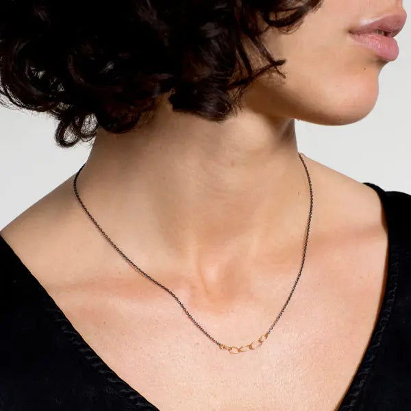 A cluster of handmade 18k gold links on 14k gold chain.