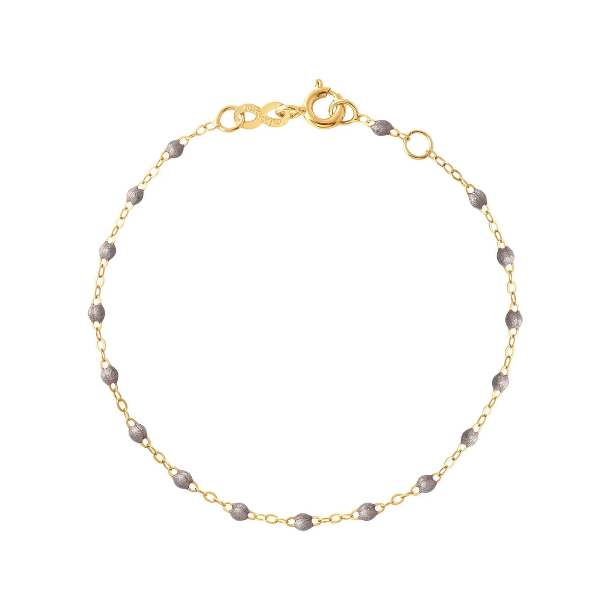 The Classic Gigi bracelet by gigi CLOZEAU features 18K Yellow Gold, and unique Gigi jewels for a simple, everyday look.   Each jewel is unique, artisanally made in their family-owned workshop. 18K yellow gold and resin. The bracelet measures 6.7 inches with adjustable clasp at 6.3 inches.
