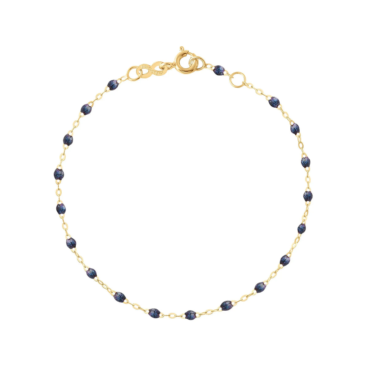The Classic Gigi bracelet by gigi CLOZEAU features 18K Yellow Gold, and unique Midnight jewels for a simple, everyday look.   Each jewel is unique, artisanally made in their family-owned workshop. 18K yellow gold and resin. The bracelet measures 6.7 inches with adjustable clasp at 6.3 inches.