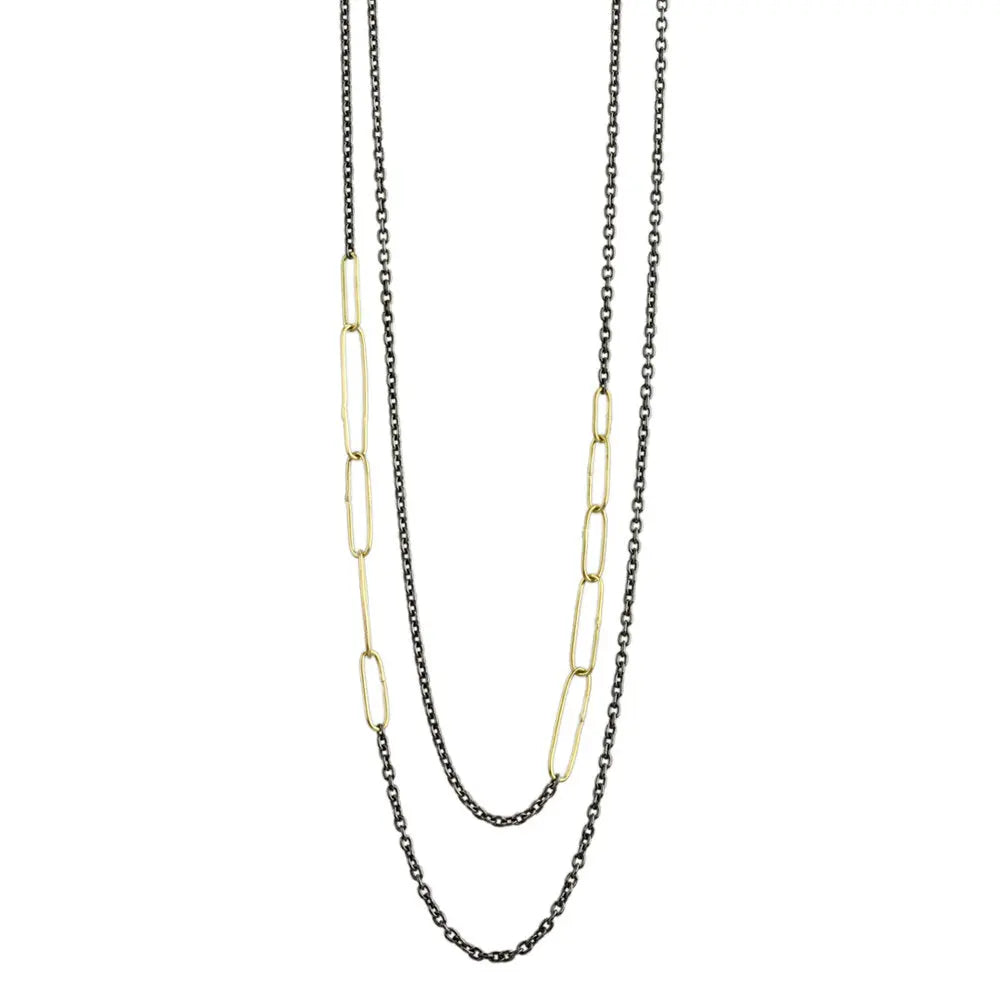 Long, versatile necklace. Oxidized silver chain with four asymmetrical  segments of handmade 18k gold links. Can be worn long or doubled.