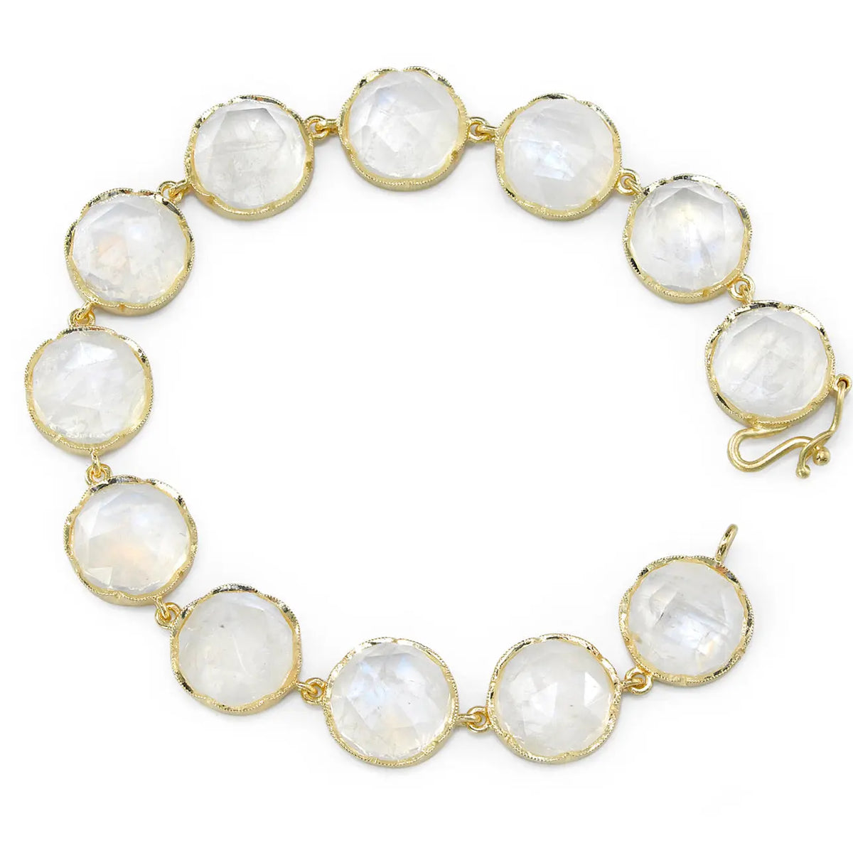 18K Gold bracelet with 11 mm rose cut moonstones. A great piece alone or a great stacking piece. Measures 7 inches long. Handcrafted hook and eye clasp with safety catch.  If an item is out of stock, please allow 4-6 weeks for delivery. Please email shop@sbvail.com for questions.