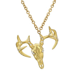 “Georgie” Deer Skull Necklace with white diamonds  Named after Georgia O'Keefe, this guy is hung slightly off kilter and is a very small skull covered in diamonds and made of 18k. He's just killer.  Designed by Feral Jewelry
